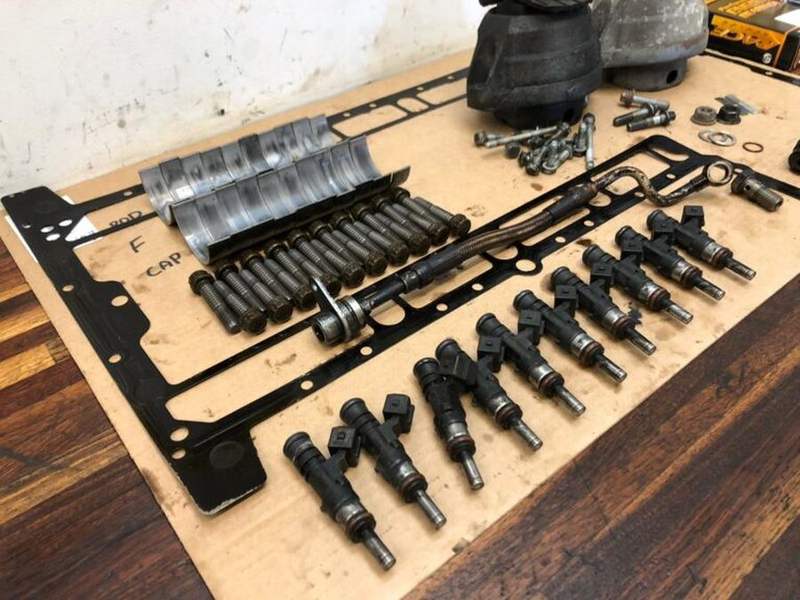 Old bearing shells and parts laid out for the owner to inspect.