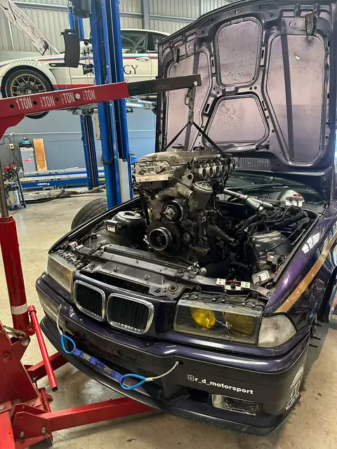 The rebuilt engine on the crane, being lowered into car 85