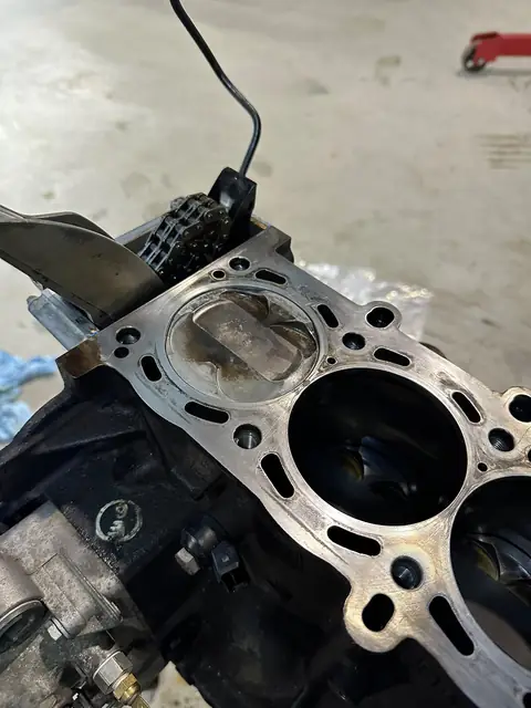 Close-up of a piston sitting in the bore of the stripped block