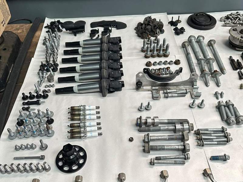 An engine stripped, every part laid out. Old parts are always kept for the owner to inspect.